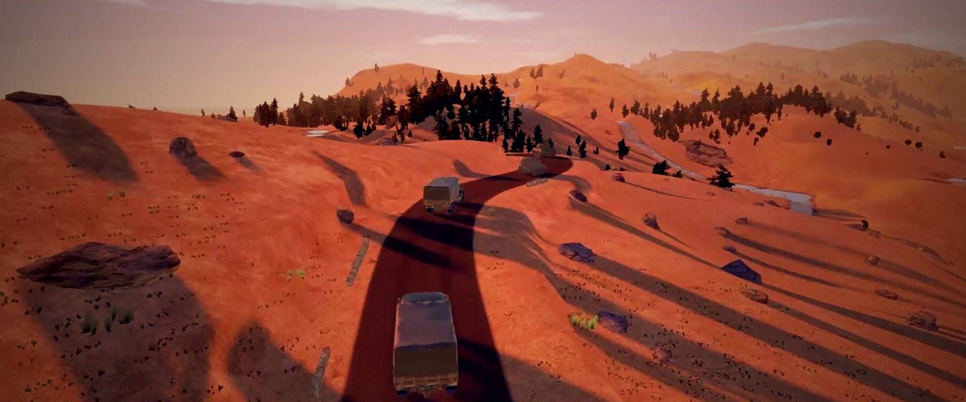A truck on a desert road at sunset